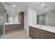 Contemporary bathroom featuring double sinks, expansive mirrors, and a luxurious glass-enclosed shower at 301 Quay Commons # 1411, Sarasota, FL 34236