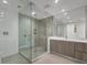 Modern bathroom featuring a glass enclosed shower and sleek vanity with a marble countertop at 301 Quay Commons # 1411, Sarasota, FL 34236