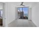 Bedroom with ceiling fan, tile floors, and floor to ceiling windows offering amazing water views at 301 Quay Commons # 1411, Sarasota, FL 34236