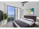 Stylish bedroom with floor-to-ceiling windows and stunning waterfront views at 301 Quay Commons # 1411, Sarasota, FL 34236
