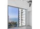 Bedroom with large windows offering ocean views, complemented by a ceiling fan and modern decor at 301 Quay Commons # 1411, Sarasota, FL 34236