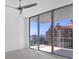 Bright bedroom offering city views from floor-to-ceiling windows and balcony access at 301 Quay Commons # 1411, Sarasota, FL 34236