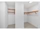 Spacious walk-in closet with built-in wooden shelving, providing ample storage space at 301 Quay Commons # 1411, Sarasota, FL 34236