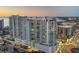 Aerial view of modern high-rise condominium building with balconies, a pool, and city views at 301 Quay Commons # 1411, Sarasota, FL 34236