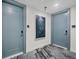 Well-lit hallway featuring neutral decor, two entry doors, and modern carpet at 301 Quay Commons # 1411, Sarasota, FL 34236