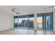 Bright living room featuring large windows with ocean views, a ceiling fan and neutral flooring at 301 Quay Commons # 1411, Sarasota, FL 34236