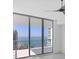 Living room featuring windows that overlook the waterfront and balcony access at 301 Quay Commons # 1411, Sarasota, FL 34236