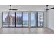 Spacious living room featuring expansive windows with stunning waterfront views at 301 Quay Commons # 1411, Sarasota, FL 34236