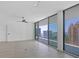 Living room with floor-to-ceiling windows that offer waterfront views and balcony access at 301 Quay Commons # 1411, Sarasota, FL 34236