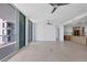 Open-concept living space with a modern kitchen, tile floors, and a sliding glass door to the outdoor balcony at 301 Quay Commons # 1411, Sarasota, FL 34236