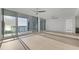 Bright living room with tile floors, ceiling fans, and floor-to-ceiling windows offering stunning water views at 301 Quay Commons # 1411, Sarasota, FL 34236