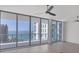 Living room featuring tiled floor, floor-to-ceiling windows with water views and plenty of natural light at 301 Quay Commons # 1411, Sarasota, FL 34236