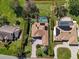 Aerial view of a home with manicured lawn, pool, and driveway, showcasing its prime location at 3336 Lakeside Cir, Parrish, FL 34219