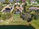 Aerial view of a home with a well-manicured lawn, pool, and a lake view, showcasing its outdoor amenities at 3336 Lakeside Cir, Parrish, FL 34219