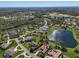 Overhead perspective of a community boasting ponds, a green golf course, and plentiful trees at 3336 Lakeside Cir, Parrish, FL 34219