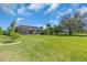 Large green backyard with a screened-in pool and patio at 3336 Lakeside Cir, Parrish, FL 34219