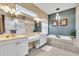 Bathroom with a soaking tub, walk-in shower, and double sink vanity at 3336 Lakeside Cir, Parrish, FL 34219