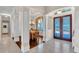 Elegant foyer with high ceilings, columns, and a dining area with a chandelier at 3336 Lakeside Cir, Parrish, FL 34219