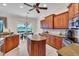Open kitchen with a center island, lots of cabinets, granite countertops and a beautiful lake view at 3336 Lakeside Cir, Parrish, FL 34219