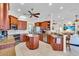 Spacious kitchen with stainless appliances, granite countertops, center island, bar seating and abundant cabinets at 3336 Lakeside Cir, Parrish, FL 34219