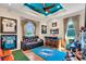 Spacious living room with team decor, wet bar, and comfortable seating, perfect for entertaining guests at 3336 Lakeside Cir, Parrish, FL 34219