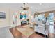Open living room area with fireplace, large flatscreen, ceiling fans, and bright, airy decor at 3336 Lakeside Cir, Parrish, FL 34219