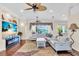Living room offering ceiling fans, hardwood floors, large windows, and modern furnishings at 3336 Lakeside Cir, Parrish, FL 34219