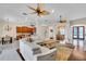 Open living space showcasing hardwood flooring, ceiling fans, and a seamless connection to the kitchen at 3336 Lakeside Cir, Parrish, FL 34219