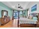 Spacious main bedroom featuring hardwood floors, tray ceilings, and access to the pool at 3336 Lakeside Cir, Parrish, FL 34219