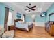 Main bedroom featuring hardwood floors, tray ceilings, and a serene color scheme at 3336 Lakeside Cir, Parrish, FL 34219