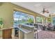 This is a bar inside an outdoor patio with a screened pool and views of the lake at 3336 Lakeside Cir, Parrish, FL 34219