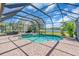 The screened-in pool features a hot tub and a view of the lake at 3336 Lakeside Cir, Parrish, FL 34219