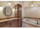 Bathroom boasts granite counters, dark cabinets, and a soaking tub with decorative tile surround at 3814 Mira Lago Dr, Sarasota, FL 34238