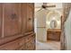 Arched entryway leads to the bathroom with granite counters and custom cabinetry at 3814 Mira Lago Dr, Sarasota, FL 34238