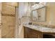 Bathroom with a granite countertop, framed mirror, and a shower featuring attractive tile and a shower curtain at 3814 Mira Lago Dr, Sarasota, FL 34238