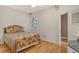 Bedroom with hardwood floors, window shutters, ceiling speakers, and a door leading to an adjoining space at 3814 Mira Lago Dr, Sarasota, FL 34238