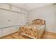 Bedroom with hardwood floors, custom shelving, and a bed covered with a floral comforter and matching pillows at 3814 Mira Lago Dr, Sarasota, FL 34238