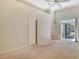 This room has a ceiling fan, neutral-colored carpet, and a door leading to the screened-in patio at 3814 Mira Lago Dr, Sarasota, FL 34238