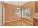 Breakfast nook has hardwood floors, chandelier lighting, and plantation shutters at 3814 Mira Lago Dr, Sarasota, FL 34238