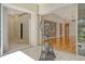 Exercise area featuring an elliptical trainer, white tile floors, and open access to other rooms at 3814 Mira Lago Dr, Sarasota, FL 34238