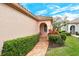 Charming home exterior with lush landscaping and brick walkway at 3814 Mira Lago Dr, Sarasota, FL 34238