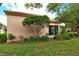 Charming home exterior featuring lush landscaping and a tiled roof, creating an inviting outdoor space at 3814 Mira Lago Dr, Sarasota, FL 34238