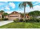 Charming single-story home featuring a tile roof, manicured lawn, and a two-car garage at 3814 Mira Lago Dr, Sarasota, FL 34238