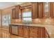 Updated kitchen features stainless steel appliances, custom cabinetry, and granite countertops at 3814 Mira Lago Dr, Sarasota, FL 34238