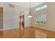 Bright living room with hardwood floors, plantation shutters, and chandelier lighting at 3814 Mira Lago Dr, Sarasota, FL 34238