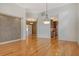 Bright living room with hardwood floors, designer wall feature, and modern lighting fixture at 3814 Mira Lago Dr, Sarasota, FL 34238