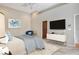 This bedroom has a blue, white, and beige color theme, a TV, and a large walk-in closet at 3814 Mira Lago Dr, Sarasota, FL 34238