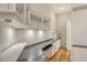 Office space with modern track lighting and a desk with granite counters and custom white cabinetry at 3814 Mira Lago Dr, Sarasota, FL 34238
