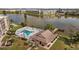 An aerial view of the community's pool, clubhouse, and a serene lake at 4126 Heron Way # B113, Bradenton, FL 34205