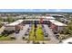 A three-story condominium community with well-maintained landscaping and ample parking at 4126 Heron Way # B113, Bradenton, FL 34205
